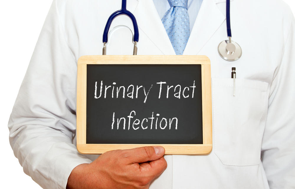 Urinary Tract Infection - Doctor with chalkboard and text on white background.